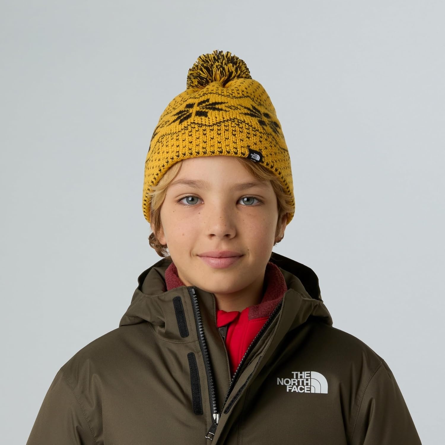 image:imageTHE NORTH FACE Kids Cabin Ski Tuke Winter Hat With Novelty Jacquard Graphic Sustainable Fabric Removable PomSummit Gold Jacquard